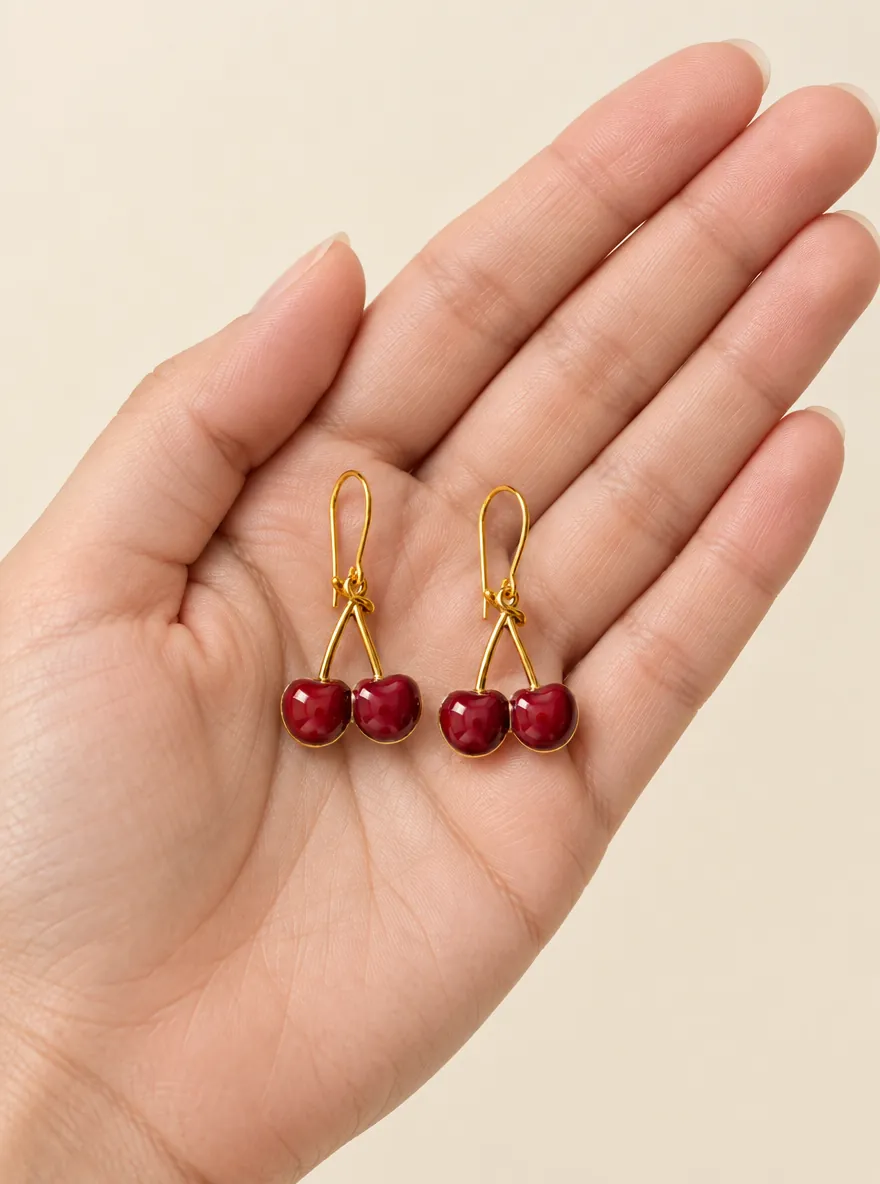 Cherry Knot Drops — In the hand, for scale