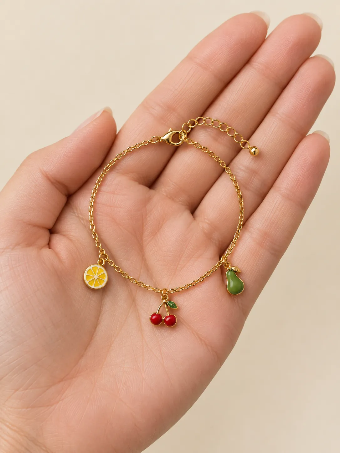 Fruit Bowl Charm Bracelet — In the hand, for scale