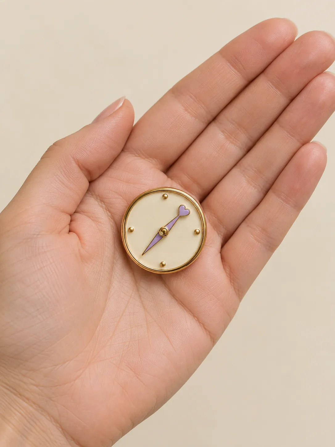 Heart Compass Brooch — In the hand, for scale