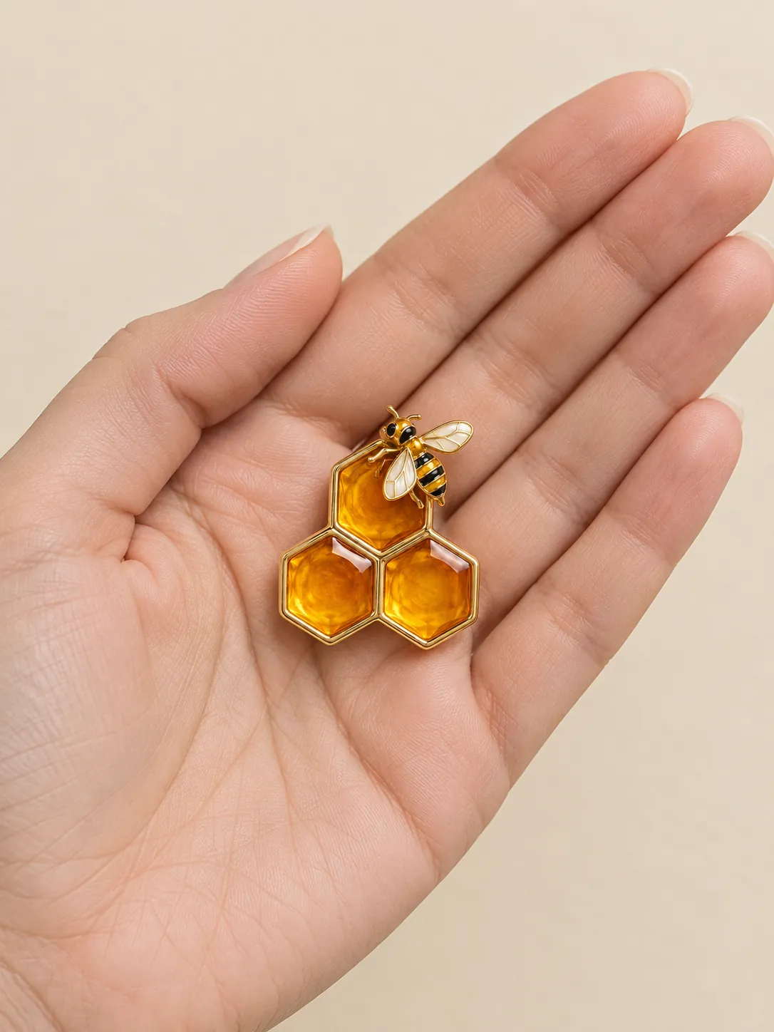 Honeycomb Keeper Brooch — In the hand, for scale