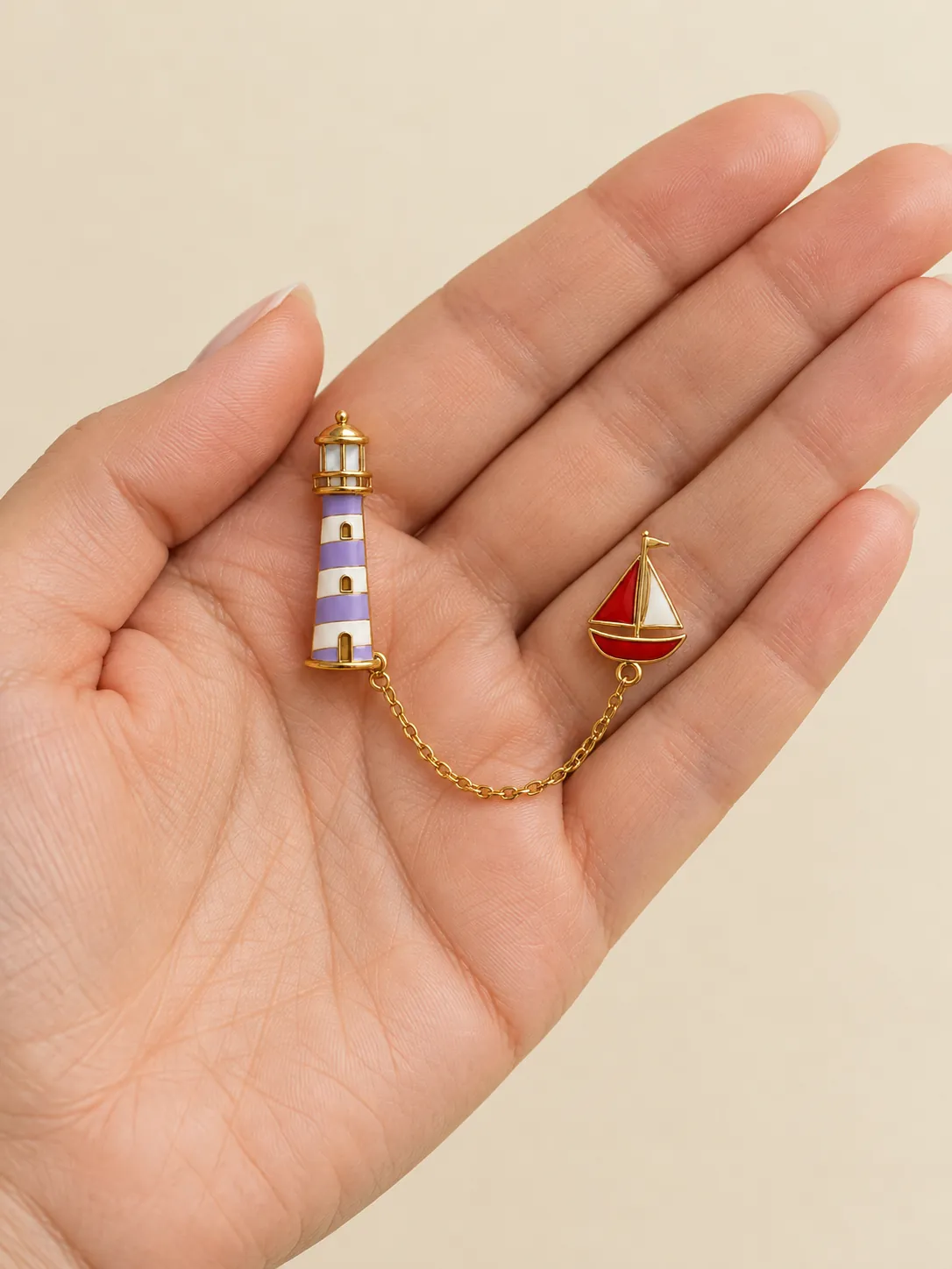Lighthouse & Little Boat Chain Brooch — In the hand, for scale