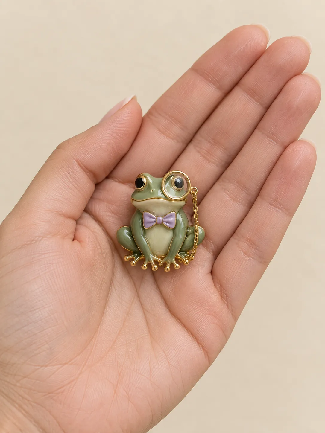 Monocle Frog Brooch — In the hand, for scale