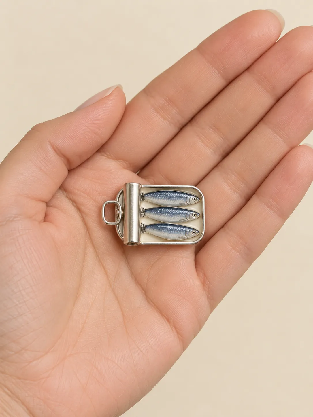 Sardine Tin Brooch — In the hand, for scale