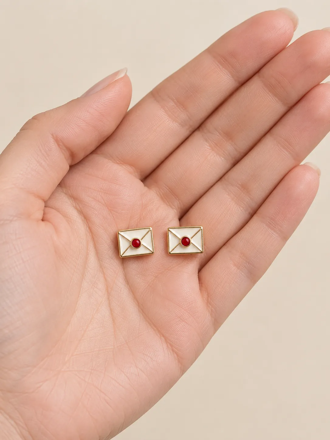 Sealed Letter Studs — In the hand, for scale