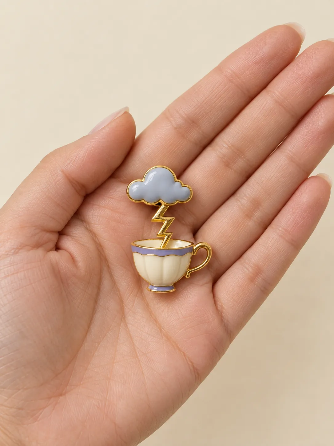 Teacup Storm Brooch — In the hand, for scale